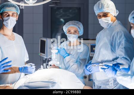 Konzentriert Op-Team den Betrieb eines Patienten in einem Operationssaal. Gut ausgebildete Anästhesisten mit Jahren Training mit komplexen Maschinen fol Stockfoto