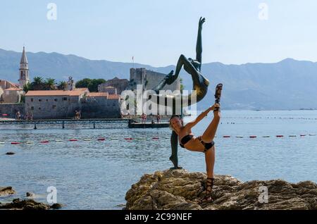 Tourist posiert für ein Foto in der Nähe der Statue Stockfoto