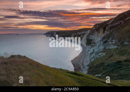 Dungey Head, West Lulworth, Dorset, Großbritannien. Juli 2020. Wetter in Großbritannien. Die Wolken sind von orangefarbenem Glanz bei Sonnenuntergang von Dungy Head bei West Lulworth in Dorset aus betrachtet und blicken nach Westen in Richtung man O'war Bay und Durdle Door. Bild: Graham Hunt/Alamy Live News Stockfoto