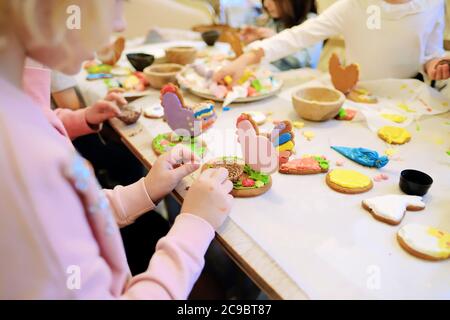 Kinderhände machen Lebkuchen. Kinder schneiden Kekse. Kinder backen Plätzchen Stockfoto