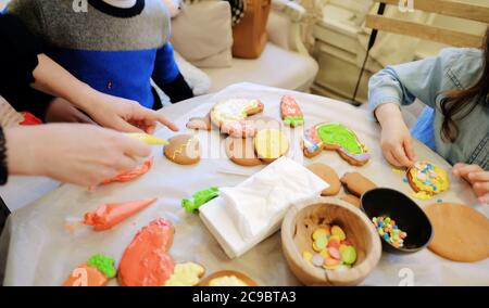 Kinderhände machen Lebkuchen. Kinder schneiden Kekse. Kinder backen Plätzchen Stockfoto