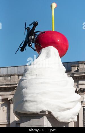 London, Großbritannien. Juli 2020. Das Foto vom 30. Juli 2020 zeigt die vierte Sockelskulptur mit dem Titel 'The End' am Trafalgar Square in London, Großbritannien. Ein neues Kunstwerk der Künstlerin Heather Phillipson wurde am Donnerstag auf dem vierten Sockel des Londoner Trafalgar Square enthüllt. Die Skulptur mit dem Titel THE END wird auf dem vierten Sockel mit einem riesigen Wirbel aus Schlagsahne, einer Kirsche, einer Fliege und einer Drohne, die ein lebendes Futter des Trafalgar Square überträgt, getoppt. Quelle: Ray Tang/Xinhua/Alamy Live News Stockfoto