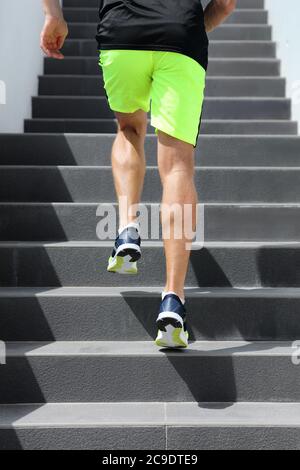 Läuferin Mann Athlet läuft die Treppe auf hiit High Intensity Intervall Training City Run. Jogging Jogger Klettern Treppe sprintet mit Geschwindigkeit Stockfoto