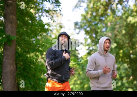 Zwei Männer joggen im Freien. Nahaufnahme des Fotos. Aktives und gesundes Lifestyle-Konzept. Selektiver Fokus. Stockfoto