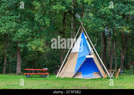 Farbenfroher Campingplatz mit Tipi- oder Wigwam-Zelten im Grünen Stockfoto