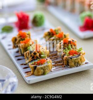 Regenbogen Sushi Roll mit Lachs, Aal, Thunfisch, Avocado, Royal Garnelen, Frischkäse Philadelphia, Kaviar Tobica, chuka. Sushi-Menü. Japanisches Essen. Stockfoto