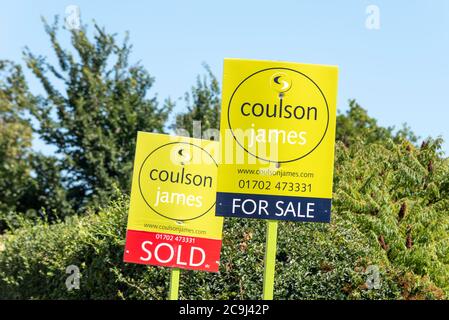 Coulson James Immobilienmakler zum Verkauf, und verkaufte Immobilienbretter. Bäume. Immobilienmarkt im exklusiven Leigh on Sea Gebiet mit grünem Hintergrund Stockfoto