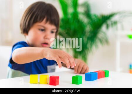 Kinderpsychologie, kleiner Junge macht Test mit Blöcken. Stockfoto
