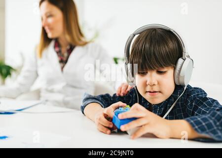 Junge, der einen Hörtest in der Praxis eines Audiologen macht. Stockfoto