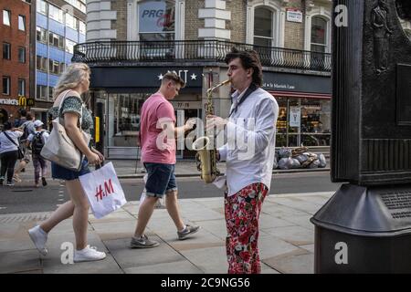 Professioneller Musiker, der während der Coronavirus-Sperre das Saxophon auf der Cranboue Street spielen muss, da die Spielstätten geschlossen bleiben, Soho, London Stockfoto