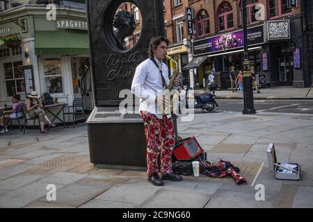 Professioneller Musiker, der während der Coronavirus-Sperre das Saxophon auf der Cranboue Street spielen muss, da die Spielstätten geschlossen bleiben, Soho, London Stockfoto