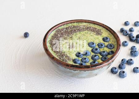 Schale Sellerie Banana Smoothie mit Chia Samen und frische Blaubeeren Nahaufnahme auf weißem Hintergrund Stockfoto