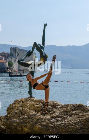 Tourist posiert für ein Foto in der Nähe der Statue Stockfoto