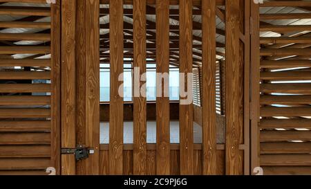 Holzsommer Strandhaus aus natürlichen Holzplanken. Außenansicht des Gartenlaube am Meer. Struktur mit Holzplankenstreifen Stockfoto