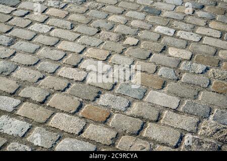 Sonne scheint auf Fliesenstein Straße Textur Stockfoto