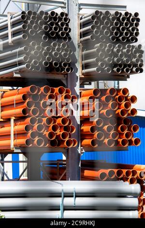 Die Kunststoffrohre werden in Regale im Freien gelagert. Stockfoto