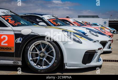 Mehrere Porsche-Rennwagen stehen auf der Estoril Racetrack in Portugal an und warten darauf, für den Porsche Império GT3 Cup vorbereitet zu sein. Stockfoto