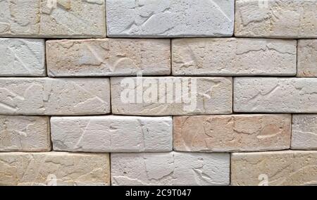 Beigefarbener Ton Steinziegel Hintergrund. Beigefarbene Backsteinwand Hintergrund Textur Nahaufnahme Stockfoto