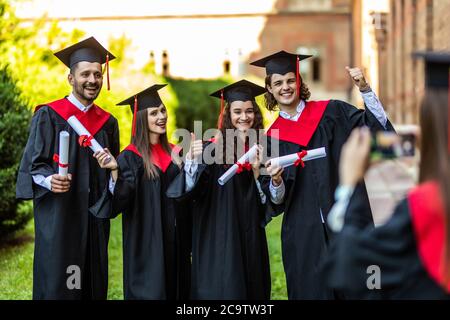 Abschlussstudenten fotografieren mit der Kamera vor der Universität Stockfoto