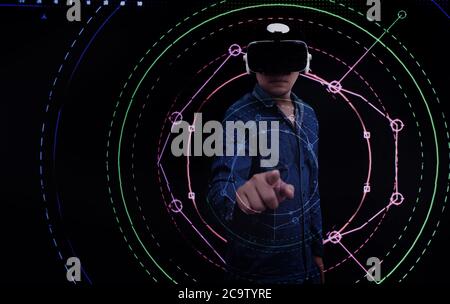 Abstrakter asiatischer Mann zeigt auf digitalen Kreis mit virtuellen Brillen in Technologie-Konzept Stockfoto