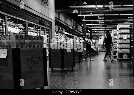 Schwarz-Weiß-Aufnahme von maskengetrackten, sozial distanzierten Käufern im lokalen Whole Foods Store, Stage 3, Ottawa, Ontario, Kanada. Stockfoto