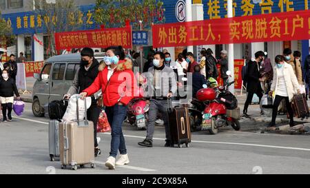 (200803) -- NANNING, 3. August 2020 (Xinhua) -- Menschen bereiten sich darauf vor, an Bord eines gecharterten Busses in die Provinz Guangdong im Bezirk Rongan, südchinesische Autonome Region Guangxi Zhuang, zu gehen, 18. Februar 2020. Guangxi, eine Schlüsselregion in Chinas Armutsbekämpfungsmission, unternimmt unermüdliche Anstrengungen, um den harten Kampf gegen die Armut zu gewinnen, indem sie die Beschäftigung der armen Bevölkerung sichert. Der Versuch, Menschen in Beschäftigung zu bringen, spielte eine entscheidende Rolle in Guangxi's groß angelegter Kampagne zur Bekämpfung der Armut, da sie die ganze Familie aus der Armut befreien kann. Es hat sich als der effektivste und direkteste Weg erwiesen, um das Abschütteln zu unterstützen Stockfoto