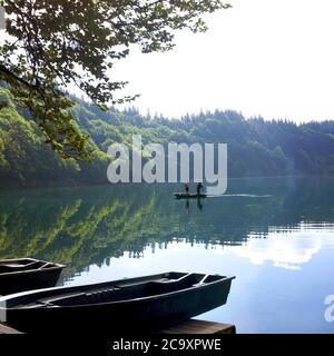 Fischer im Boot auf vulkanischem Pavinsee, vulkanischem See, Vulkane-Naturpark Auvergne, Puy de Dome, Frankreich Stockfoto