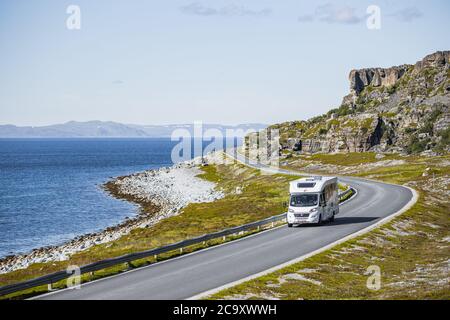 Ein Reise-Wohnwagen oder Wohnmobil auf der landschaftlich reizvollen Kreisstraße 889 nach Havøysund im Norden Norwegens im Sommer Stockfoto