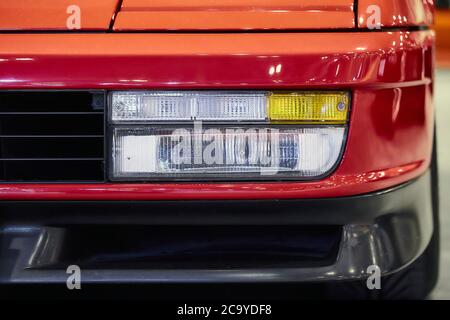 Nahaufnahme des Scheinwerfers eines roten LKWs eingefangen Unter künstlichem Licht Stockfoto