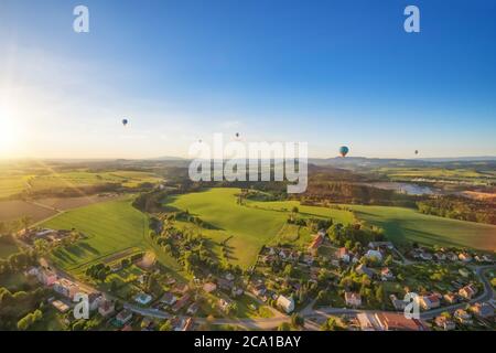 Gruppe von Heißluftballons fliegen über die ländliche Landschaft der Tschechischen republik, Europa. Flugreisen und Transport, wunderschöne Naturlandschaft Stockfoto