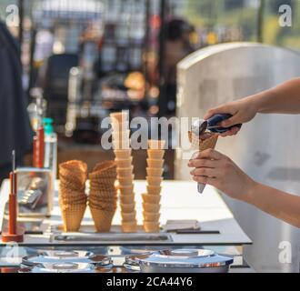 Weibliche Verkäuferin verkauft Eis auf Naplavka Bauern Straße Lebensmittelmarkt in Prag, Tschechische Republik. Stockfoto