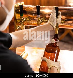 Mann gießt, Bierflasche füllen Stockfoto