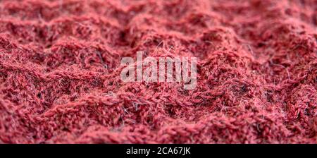 Handgestrickte Wolle Koralle Stoff Textur als Hintergrund. Banner. Nahaufnahme Stockfoto