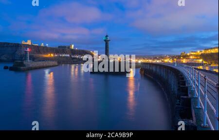 Blick auf den Eingang zum Whitby Harbour in der Abenddämmerung Stockfoto