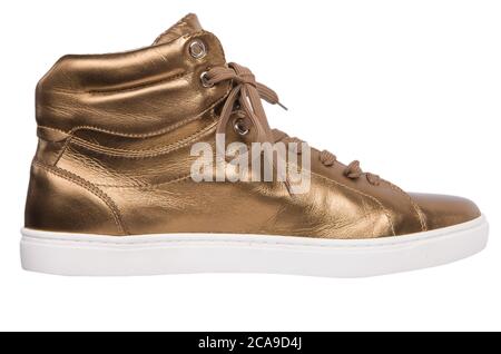 Sneaker. Golden Sneaker auf weißem Hintergrund. Stockfoto