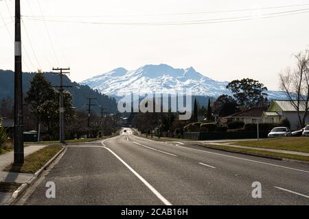 Leere Straße in Ohakune, Neuseeland im Winter, mit dem Berg Ruapehu und dem Turoa-Skigebiet im Hintergrund. Stockfoto