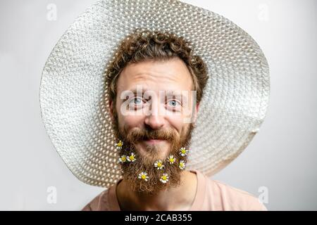 Angenehm, gutherzig glücklich Hipster Kerl lächelt an der Kamera, drückt positive Emotionen Sympathie und große Liebe. Fröhlicher romantischer Blumenmann mit dai Stockfoto