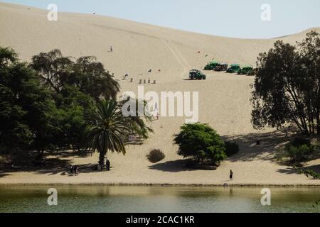 Und Dünenbuggys und Touristen auf Sanddünen rund um Huacachina Oase in Ica, Peru Stockfoto