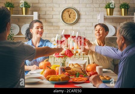 Alles Gute Zum Erntedankfest! Herbstfest. Familie sitzt am Tisch und feiert Urlaub. Traditionelles Abendessen. Großeltern, Eltern und Kinder. Peo Stockfoto