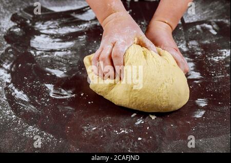 Frau Knetteig mit hans für die Herstellung von hausgemachtem Brot. Stockfoto