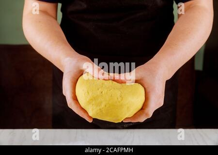 Eine Frau hält schuppigen Teig für die Herstellung von Zuckerkekse. Stockfoto