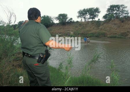 Männlicher Hispanic-US-Grenzpolizei-Agent durchsucht den Rio Grande, die Grenze zwischen Mexiko und den Vereinigten Staaten, nach Migranten, die versuchen, illegal in die USA in der Nähe von Brownsville, Texas, einzureisen. ©Bob Daemmrich Stockfoto