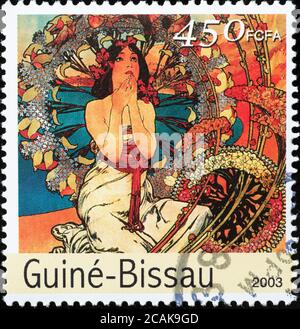 Illustration von Alfons Mucha auf Briefmarke von Guinea Bissau Stockfoto