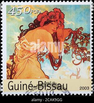 Illustration von Mucha auf Briefmarke von Guinea Bissau Stockfoto