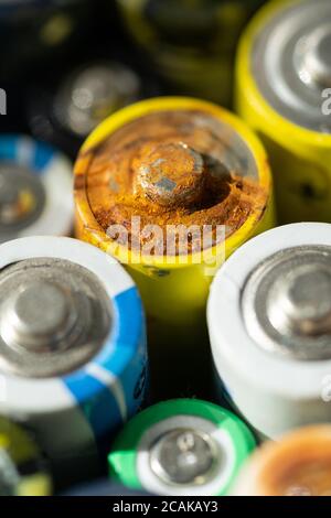 Nahaufnahme von positiven Enden entladener Batterien in verschiedenen Größen und Formaten, selektiver Fokus. Gebrauchte Batterie mit Korrosion und Rost. Gefährliche gar Stockfoto