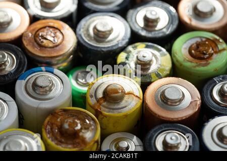 Nahaufnahme von positiven Enden entladener Batterien in verschiedenen Größen und Formaten, selektiver Fokus. Gebrauchte Batterie mit Korrosion und Rost. Gefährliche gar Stockfoto