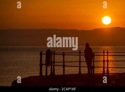 Murmbles, Swansea, Großbritannien. August 2020. Beobachten Sie den Sonnenaufgang vom Parkplatz Knab Rock in der kleinen Stadt Mumbles in der Nähe von Swansea am frühen Morgen. Quelle: Phil Rees/Alamy Live News Stockfoto