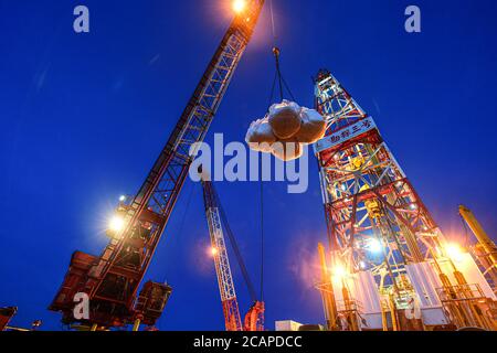 (200808) -- HAIKOU, 8. August 2020 (Xinhua) -- EINE Charge von Versorgungsgütern wird auf der Kantan No.3 Offshore-Ölplattform in den nördlichen Gewässern des Südchinesischen Meeres übertragen, 26. Juli 2020. Die Kantan No.3 ist eine semi-tauchfähige Ölplattform, die 1983 von China im Inland entwickelt wurde. Seine 18 Bohrteam-Mitglieder arbeiten 12-Stunden-Schichten non-stop, um marine Öl-und Gas-Ressourcen, die oft in Meeresböden gefunden werden 5,000 bis 6,000 Meter unter Wasser. Das Leben auf der Ölplattform ist geprägt von Mühsal und Langeweile, denn das Wetter ist heiß und es gibt kein Handy-Signal. In der Regel das We Stockfoto