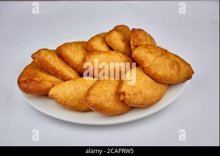 goldene Torten mit Kartoffeln auf weißem Hintergrund Stockfoto