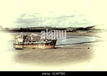 Altes Baggerboot am Küstenstrand von Ferryside Carmarthenshire Wales, ein beliebtes Touristenattraktionsziel Des an Stockfoto